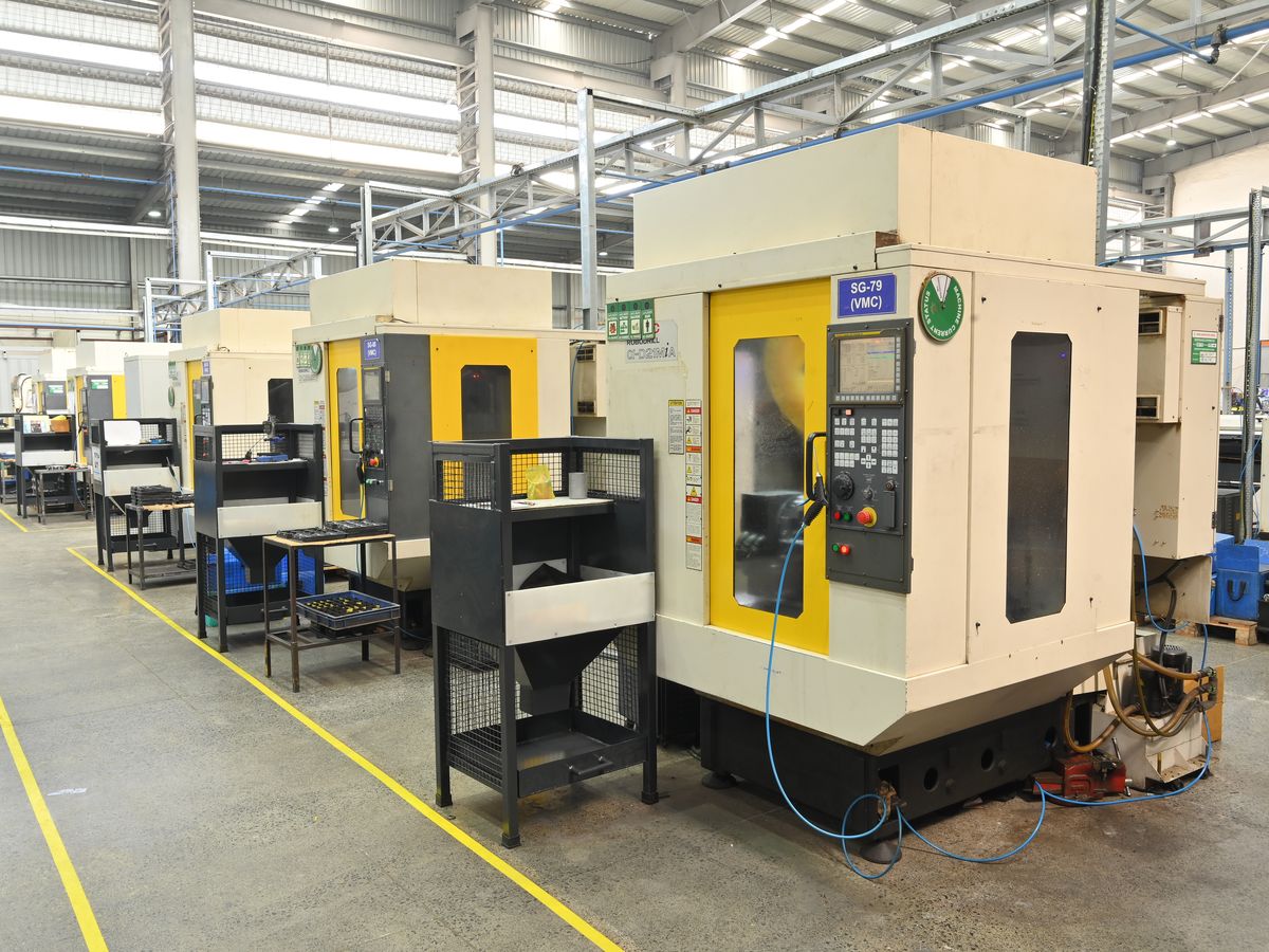 Row of vertical machining centres (VMC) on a CNC machining shop floor